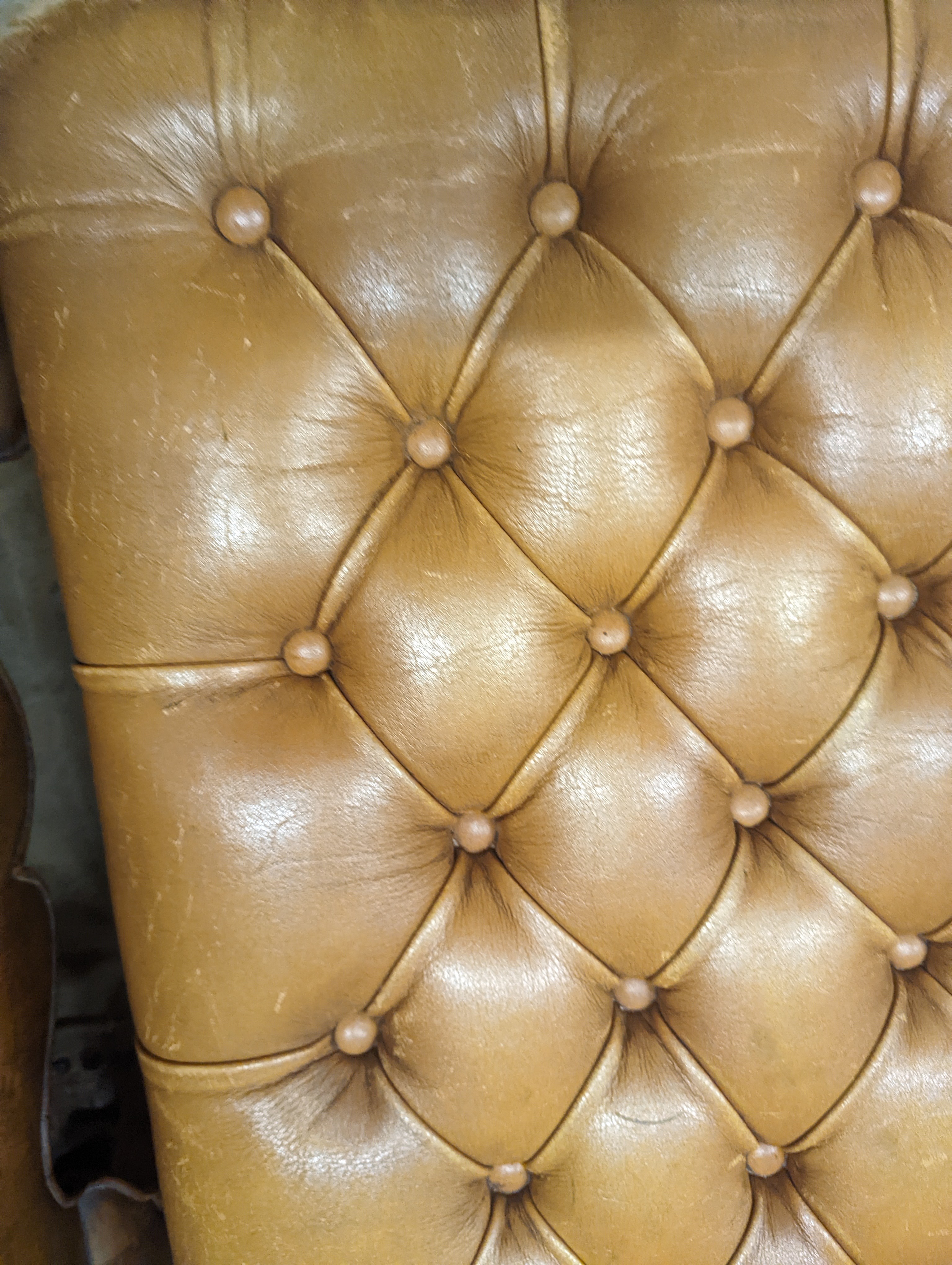 A Victorian carved X-framed rosewood footstool, upholstered in a buttoned brown leather, width 90cm depth 57cm height 42cm